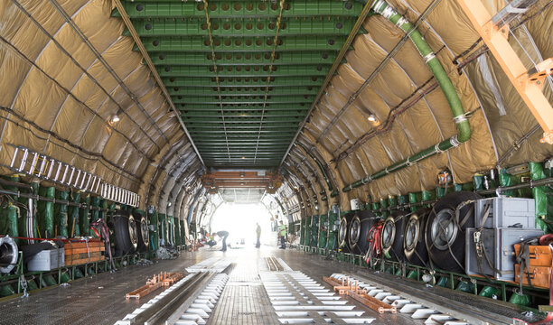 MALPENSA AIRPORT, ITALY - SEPTEMBER 14, 2021: The Huge Antonov 124-100 during loading operations, before the take off. Big interiors detail.