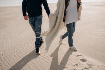 feet of a couple of lovers on the white sand on the beach
