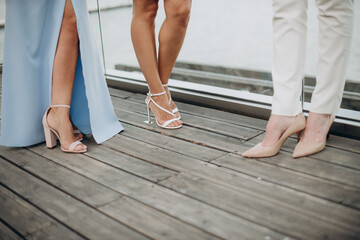 legs of bridesmaids in elegant evening dresses at a bachelorette party