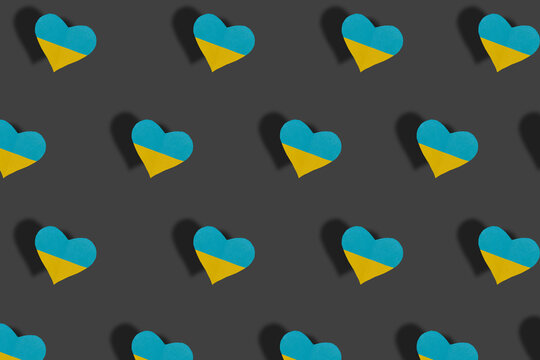hearts in the color of Ukrainian flags pattern on a gray background, peace, no war
