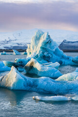 Spectacular glacial lagoon with huge floating icebergs with a winter sunset sky (Jokusarlon,...