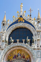 Ornate sculptures and decorations on the exterior of the ancient Basilica of St Marks in the city of Venice