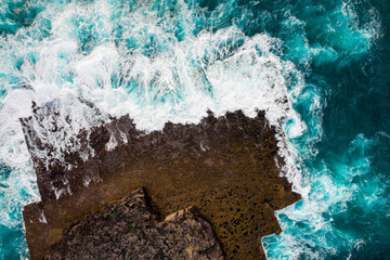 Aerial view on rough stone coast with cliff and blue ocean water. Inishmore, Aran islands, Ireland.