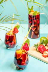 Preparation of traditional Spanish summer drink Sangria with fresh fruits, red wine and ice cubes.