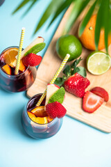 Preparation of traditional Spanish summer drink Sangria with fresh fruits, red wine and ice cubes.