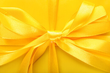 Shiny yellow ribbon bow, closeup