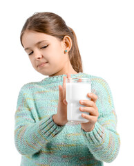 Little girl with lactose intolerance on white background