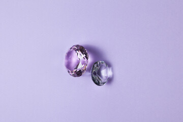 Purple precious gemstones for design gems jewellery. Diamonds crystal on turquoise background.