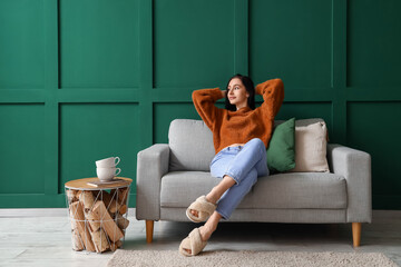 Beautiful young woman resting on couch at home