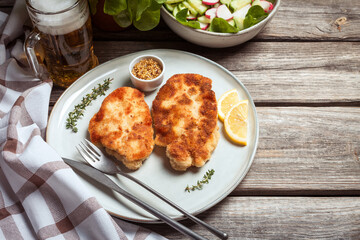 Breaded schnitzel with fresh salad. Food background. Top view