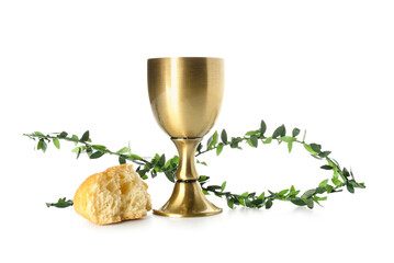 Cup of wine with bread and branches on white background