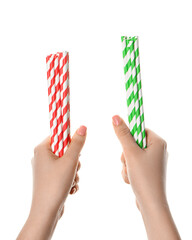 Female hands with stylish straws for drinks on white background