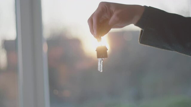 A real estate businessman giving keys in slow-motion to the woman who just bought a new apartment