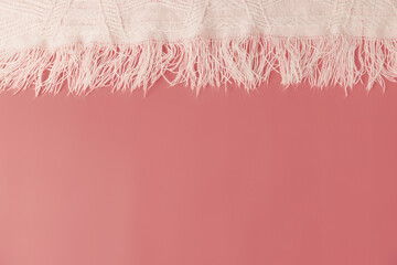 A pink coral background with a fringe blanket top header