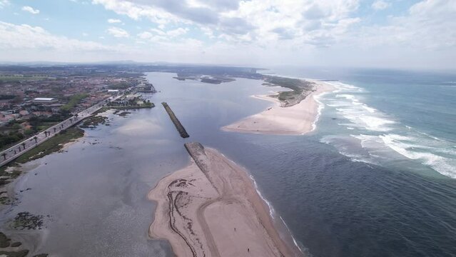 DRONE AERIAL FOOTAGE: Northern Litoral Natural Park in Ofir, Fao, Esposende, Portugal. The two sides of Restinga de Ofir. One facing the ocean, the other the estuary of C&aacute;vado River.