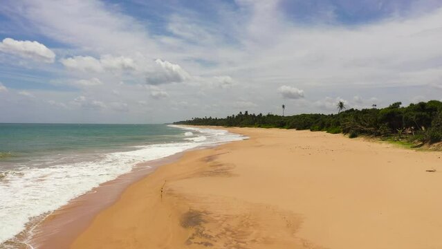 Aerial drone of Seascape with tropical sandy beach and blue ocean. Lankavatara, Sri Lanka.