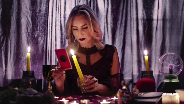 Fortune teller tarot reader looking at card and reading future and fortune