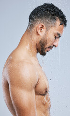 The shower is the best place to get lose in your thoughts. Studio shot of a handsome young man taking a shower against a grey background.