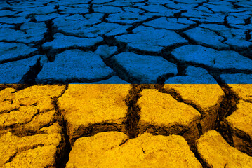 ukrainian flag over cracked ground - 498651759