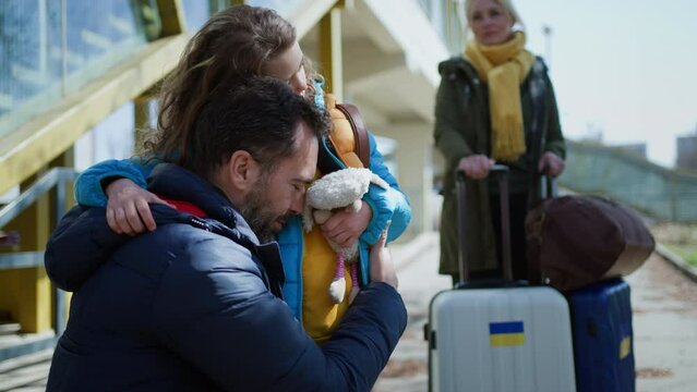 Close-up of Ukrainian girl hugging her father and saying goodbye before leaving, Ukrainian war concept.