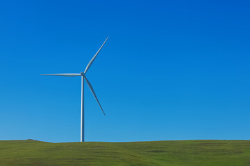 Fototapeta premium Electrical wind power mill over the blue sky.