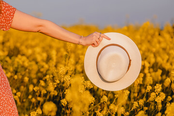 Woman's hand holding a hat close-up