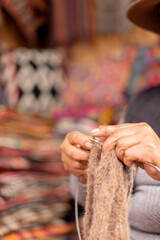 Women's hands weaving weaving baby alpaca wool in a handicraft shop