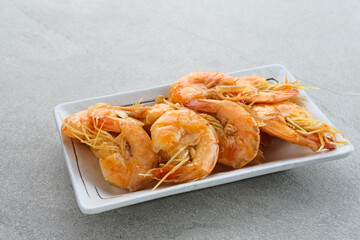 Udang Asam Manis, Sweet and sour shrimp, Indonesian food, seasoned with tomato and chilli sauce. Served in a plate, close up.
