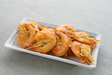 Udang Asam Manis, Sweet and sour shrimp, Indonesian food, seasoned with tomato and chilli sauce. Served in a plate, close up.
