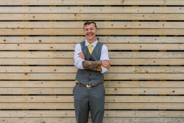 Modern groom in urban downtown, grey suit, grey and yellow