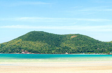 Fototapeta premium Panorama landscape beach background in Thailand.light blue sky, green mountain background, sea wave and sand beach in pastel style. Concept of summer vacation and holiday tourism.
