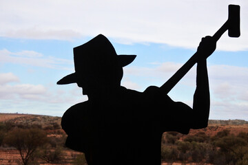 Silhouette of Australian adult man digging during a search for gold