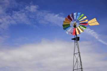 Colorful wind mill isolated on blue sky