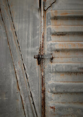 Metal locked padlock at Vintage railroad container doors gates in old station. Doors of old...
