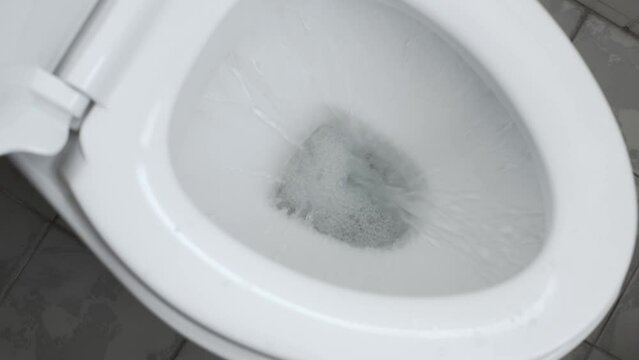Flushing water in the toilet bowl. Cleanliness of sanitary ware.
