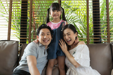 Portrait of happy asian family spending time together in living room. family and home concept