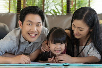 Portrait of happy asian family spending time together in living room. family and home concept