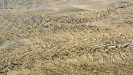 Pattern made in the sand by a river flowing to the sea, in Canoa, Ecuador