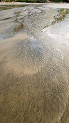 Pattern made in the sand by a river flowing to the sea, in Canoa, Ecuador