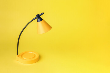 Minimal concept. Yellow table lamp on a bright yellow background.