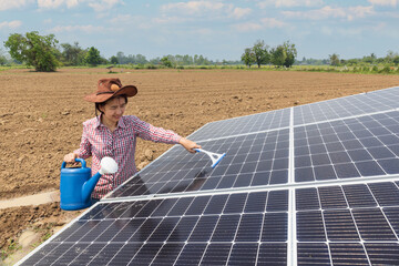 Female farmer cleaning solar panels in farm