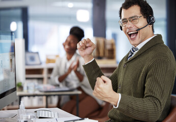 When one of us wins, we all win. Shot of a two colleagues celebrating success in an office at work.