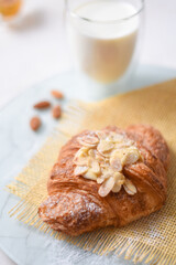 Baked croissant with a cup of milk closeup for breakfast. food photography