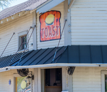 Entrance, Sign And Diners At Toast Restaurant On Gentilly Boulevard In New Orleans On April 9, 2022 In New Orleans, LA, USA