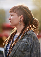 On top of the latest trends. Shot of a young woman with dreadlocks and piercings posing outdoors.