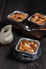 Bread pudding or puding roti tawar topping with almond slice and dried cranberry.