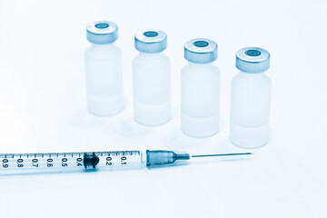 Vial of Drugs and 1 ml Plastic Syringe with Needle Isolated on the White Background