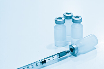 Vial of Drugs and 1 ml Plastic Syringe with Needle Isolated on the White Background