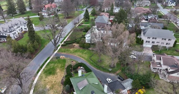Historic old restored homes in American small town. Spring season aerial rooftop view. Tilt up reveal. Hershey Pennsylvania.