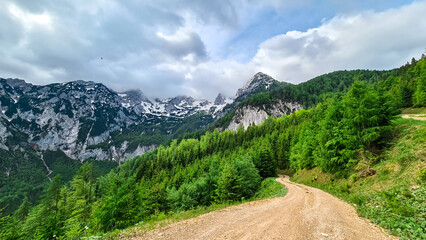 Fototapeta premium A hiking path with scenic view on mountain peaks of Kamnik Savinja Alps in Carinthia, border Austria and Slovenia. Trail to Velika Baba in Vellacher Kotschna. Mountaineering. Freedom concept. Europe